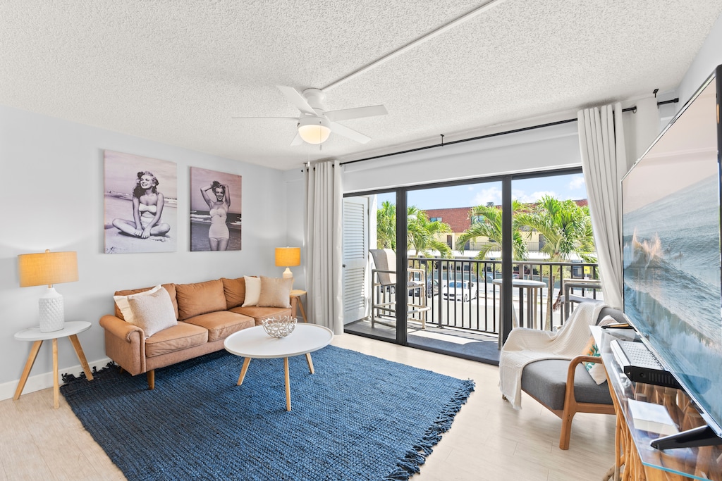 Stylish family room with a 65" TV and direct balcony access