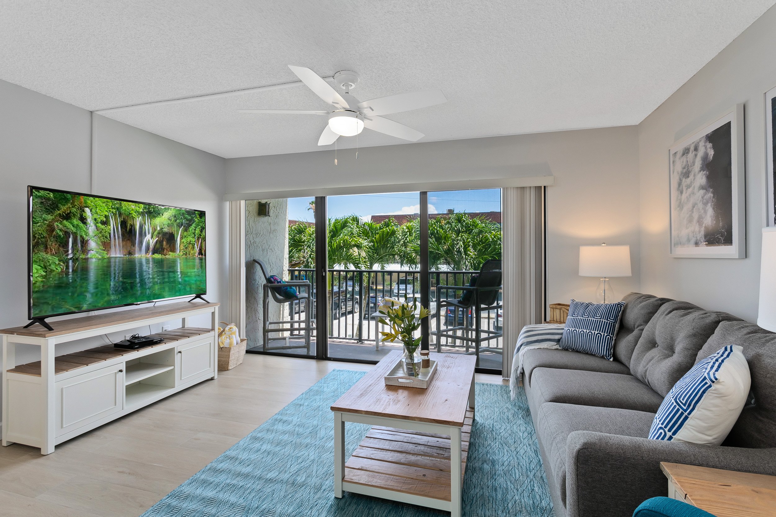 Beautiful bright living room with a 65 inch TV. The entire property was just renovated.