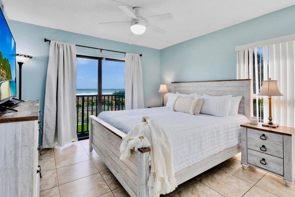Master bedroom featuring a king-size bed and ocean views
