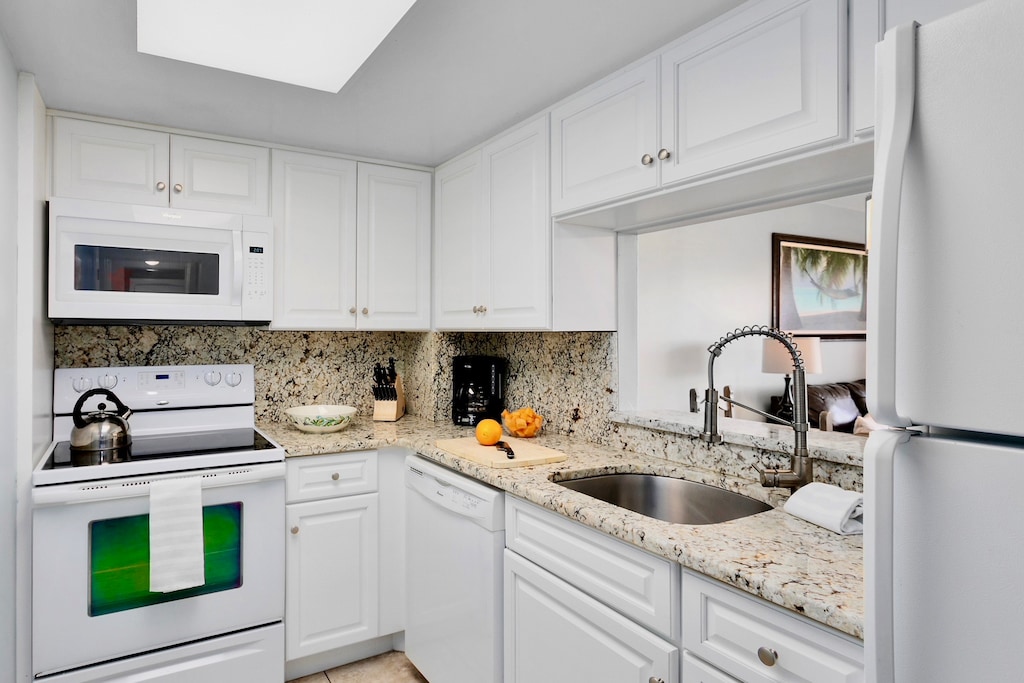 Fully equipped kitchen with modern appliances and granite countertops