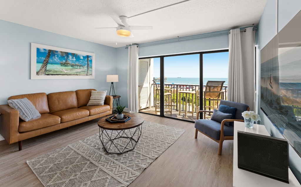 Step into a cozy living space filled with sunlight and a stunning view