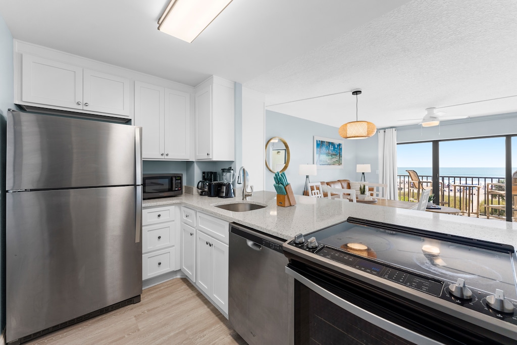Sleek kitchen with stainless steel appliances and an open-concept design.