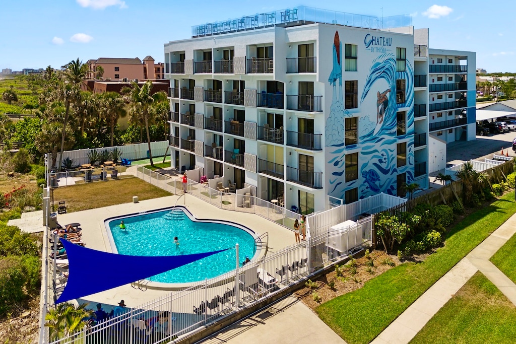 Resort-style amenities featuring a spacious pool and stunning mural backdrop.