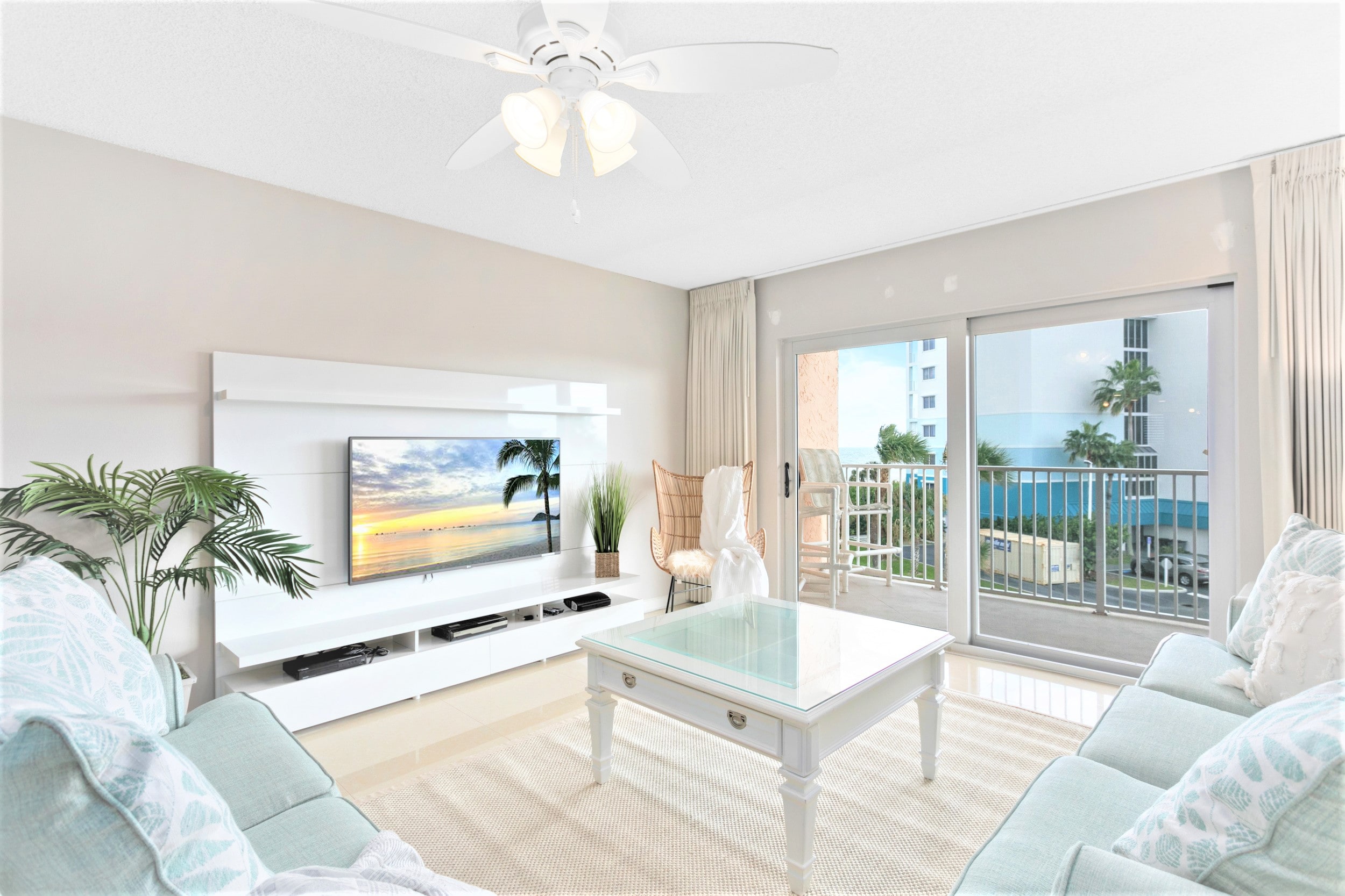 Spacious living room with 60" LCD TV, sleeper sofa, walks out onto massive private balcony with view of the ocean