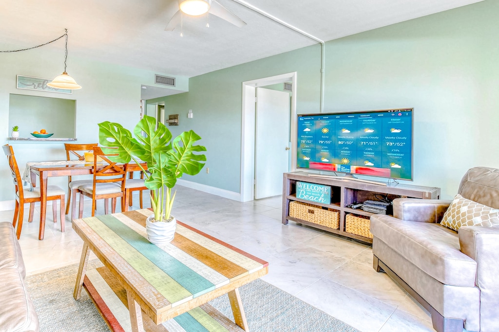 Relax in a bright and beachy living space with a cozy dining area