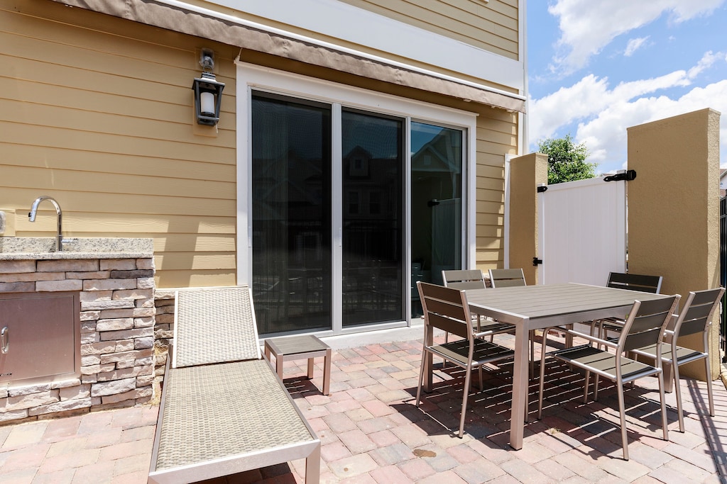 Enjoy a cozy patio complete with BBQ grill, sun loungers, and a private hot tub, ideal for relaxing evenings after a day at the parks.