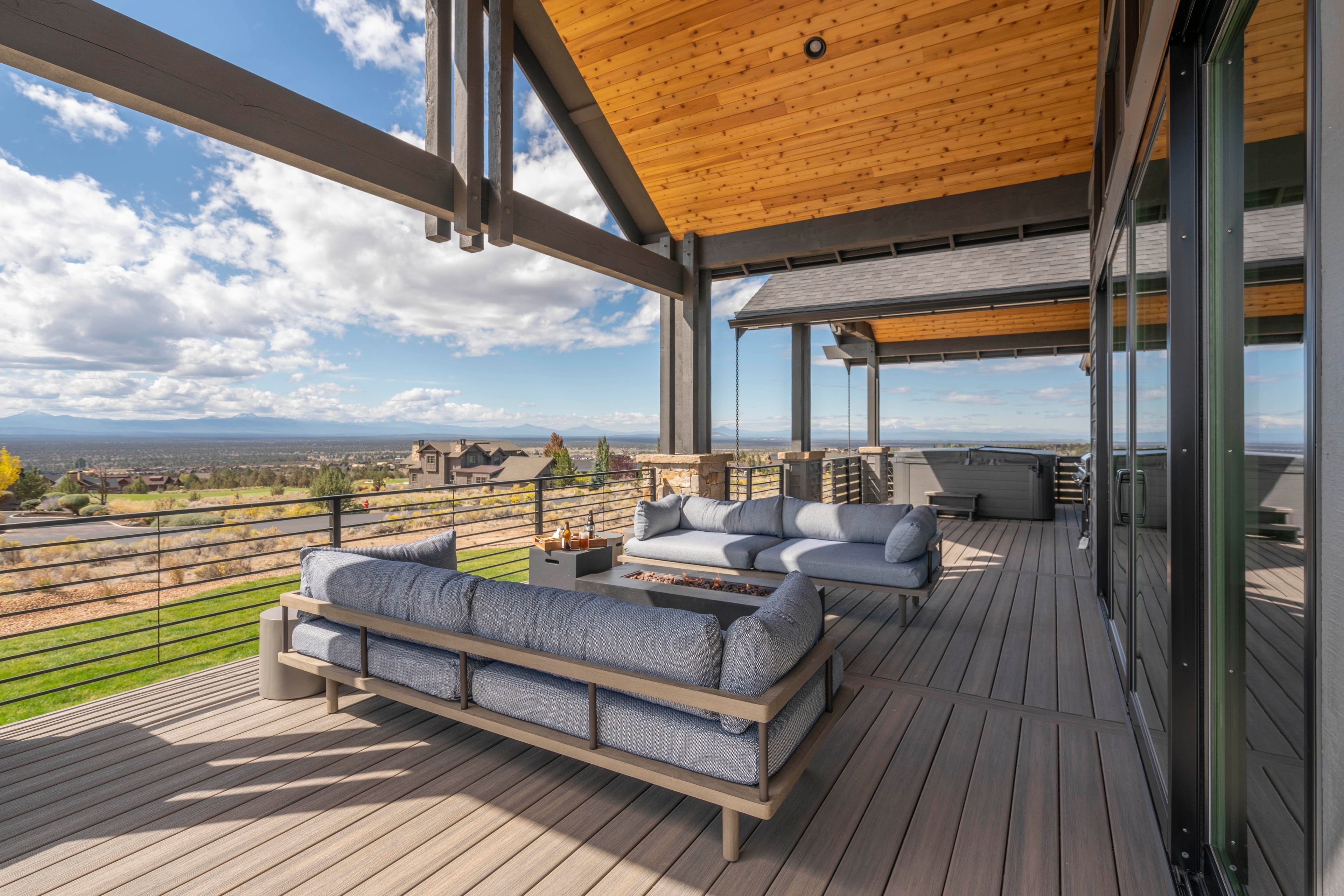 Spacious deck with fire pit and hot tub.