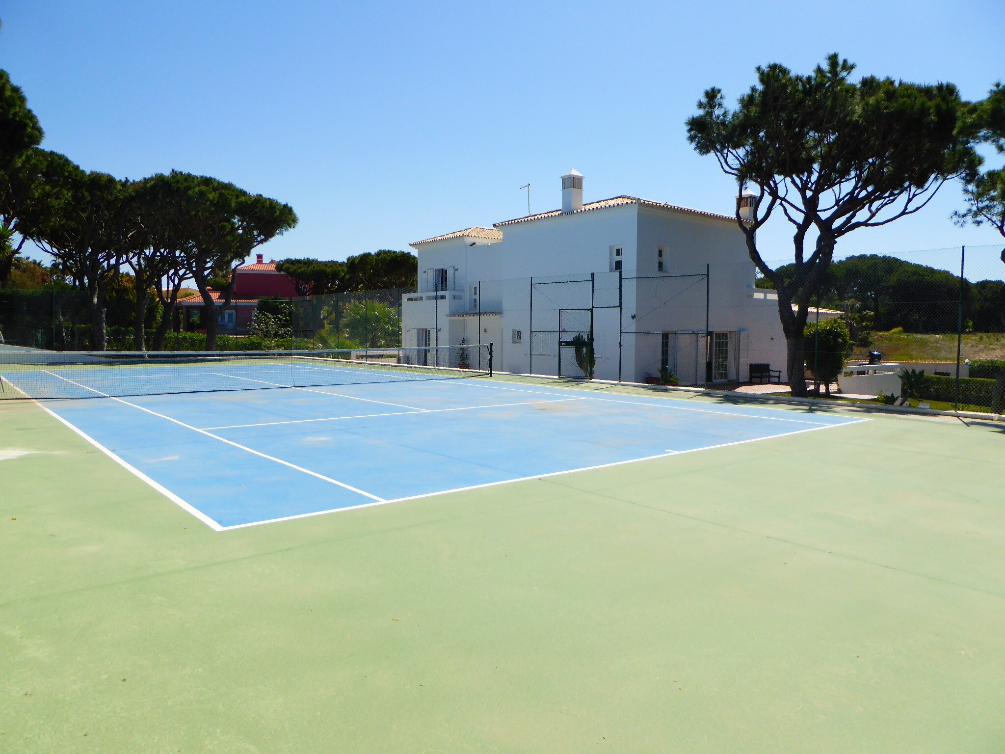 Tennis court and back of the house.