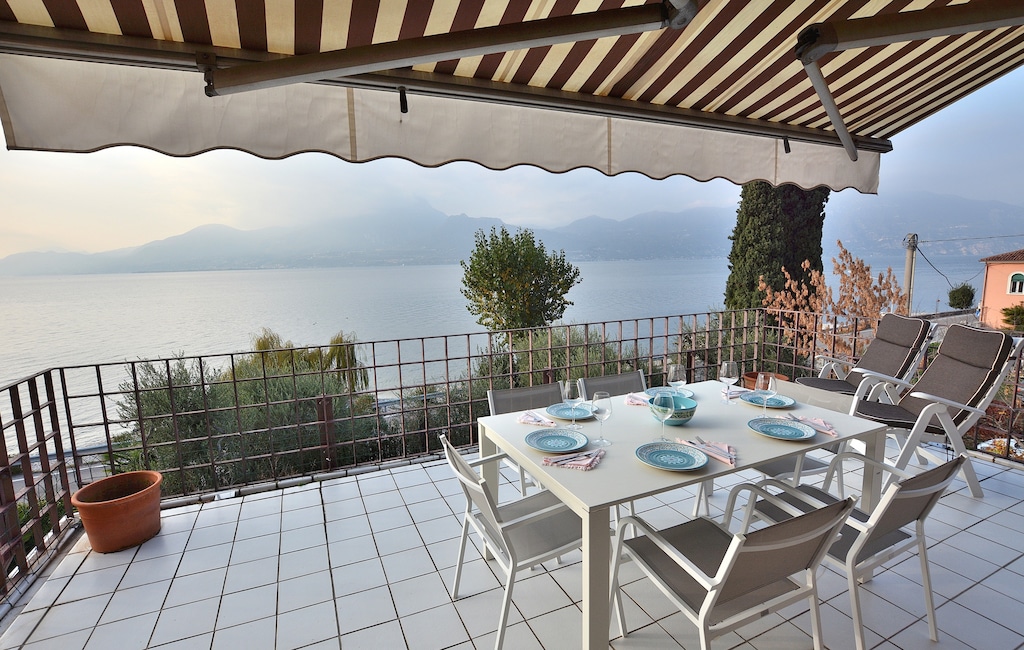 Terrace with table with BBQ and lake view