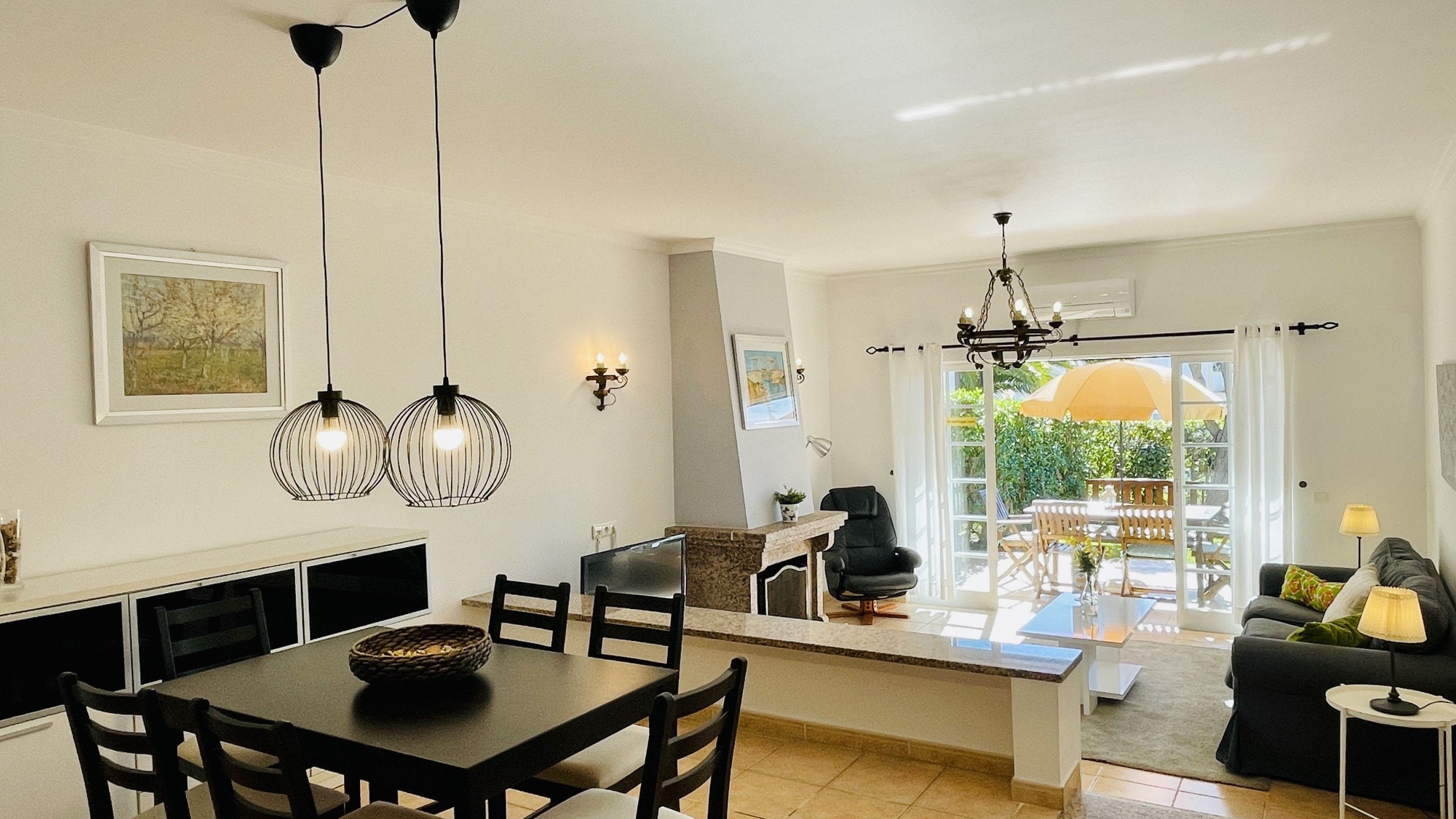 Spacious living and dining room with direct access to the terrace and small private garden.
