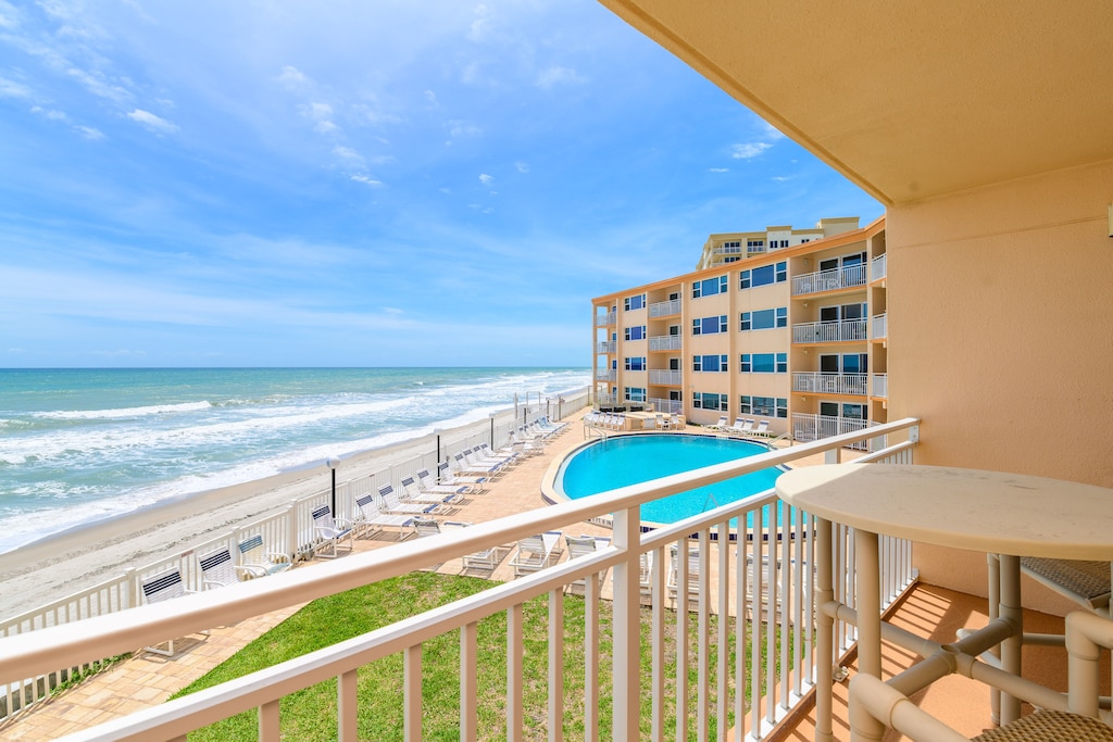 Step out onto the private balcony and take in the stunning ocean and pool views.