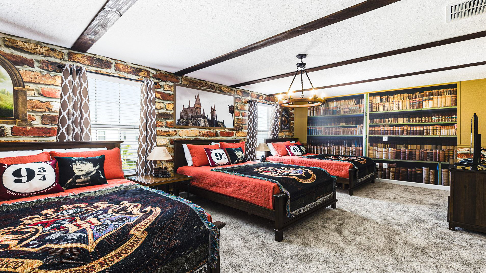 Immerse yourself in the magical world with this Harry Potter-themed bedroom featuring three full-sized beds.