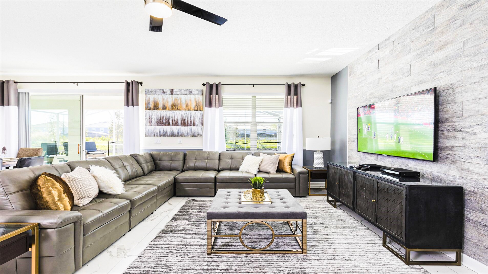 Generously sized living room featuring a cozy sofa, creating the ideal setting for a family reunion.