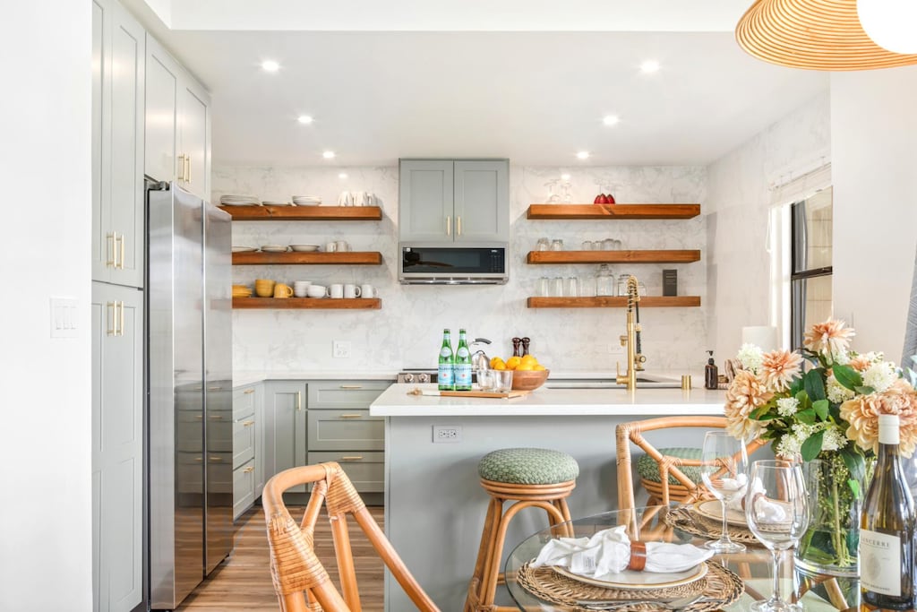 Bright kitchen with quartz counters, breakfast bar, and open shelving - newly renovated!