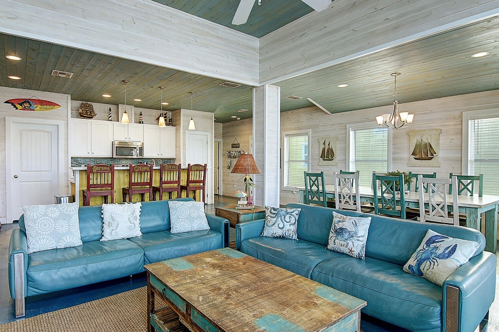 Living room and dining room. Open-concept coastal charm — where the living room, dining area, and kitchen flow together for effortless vacation living