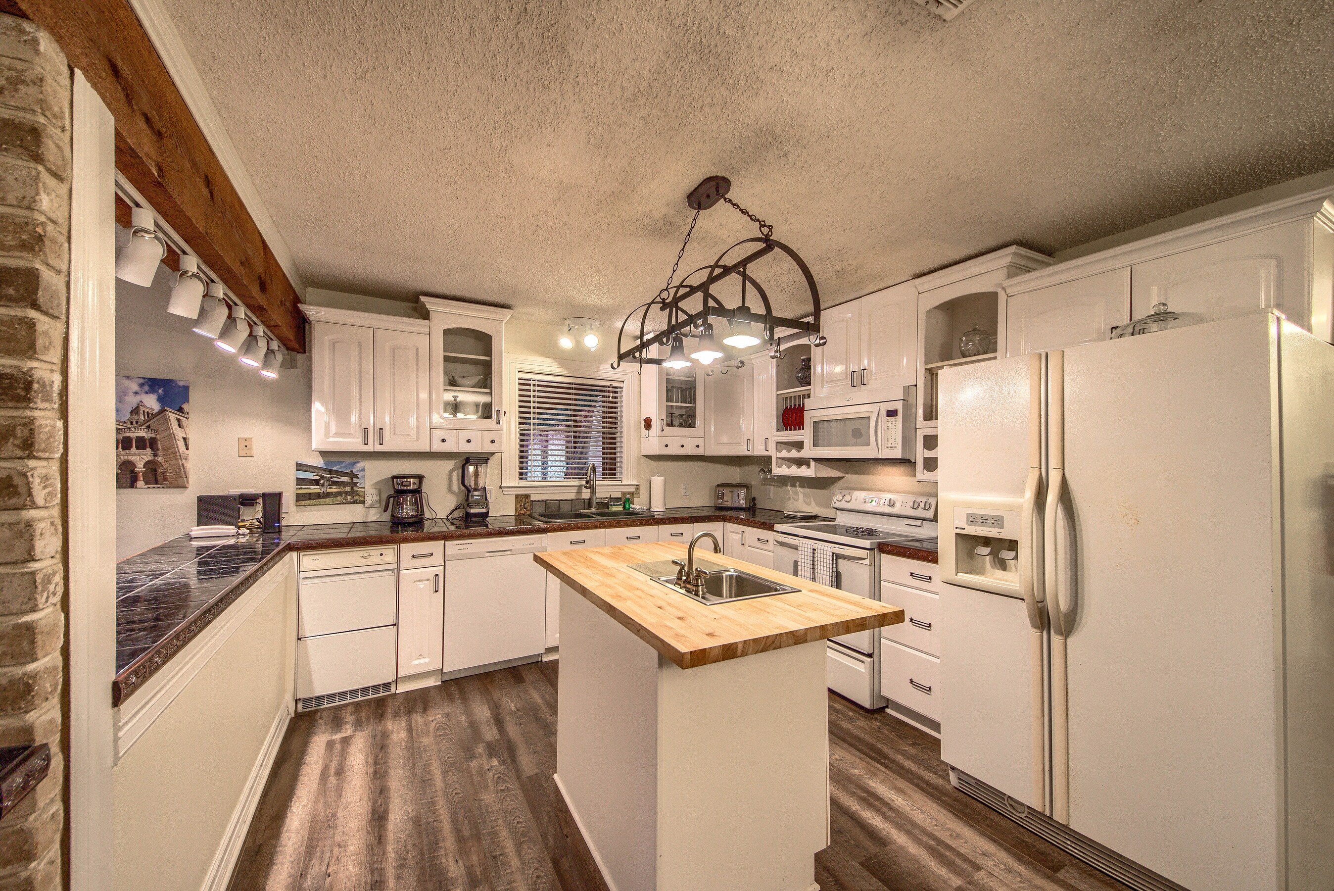 Spacious fully stocked kitchen with island.