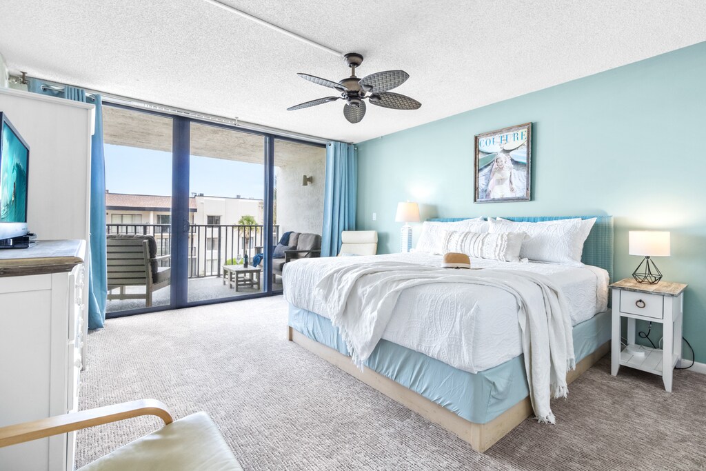 Master bedroom with king bed, soft hues, and a relaxing ambiance