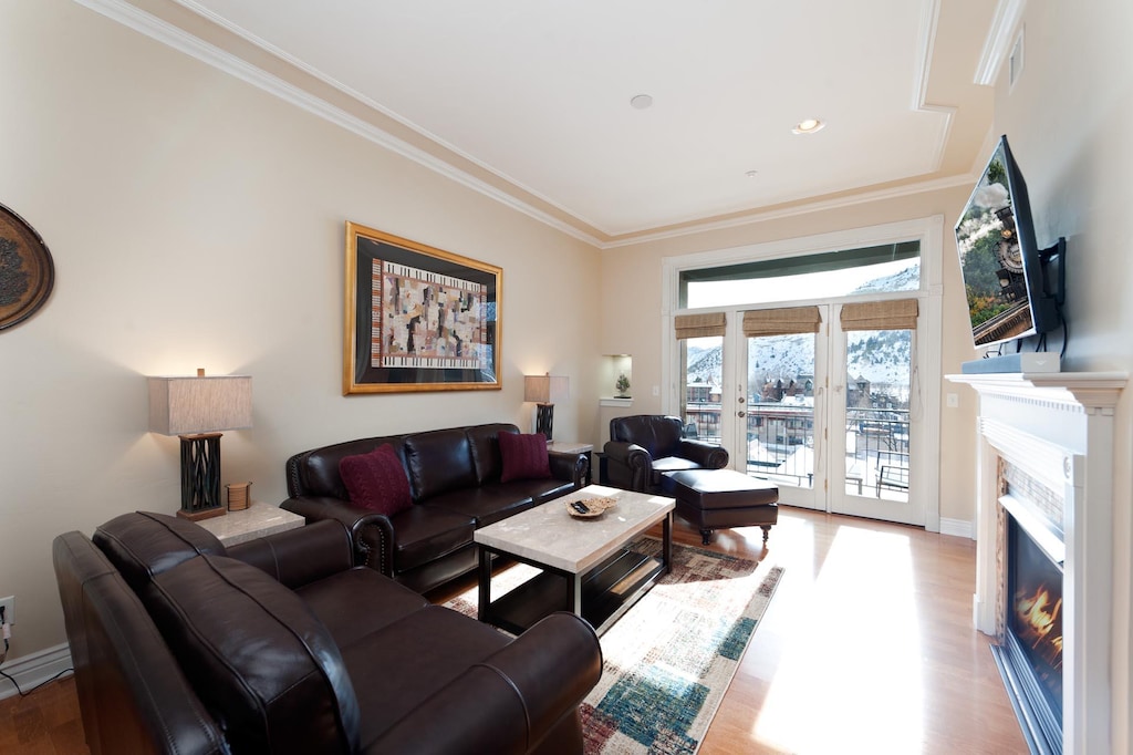 Downtown Durango Condo - Mears 3C. Living room with fireplace, tv, and mountain views. Located right across the street from the historic train.