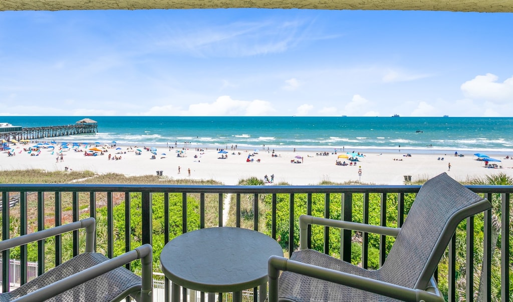 Relaxing balcony seating with breathtaking ocean and beach views
