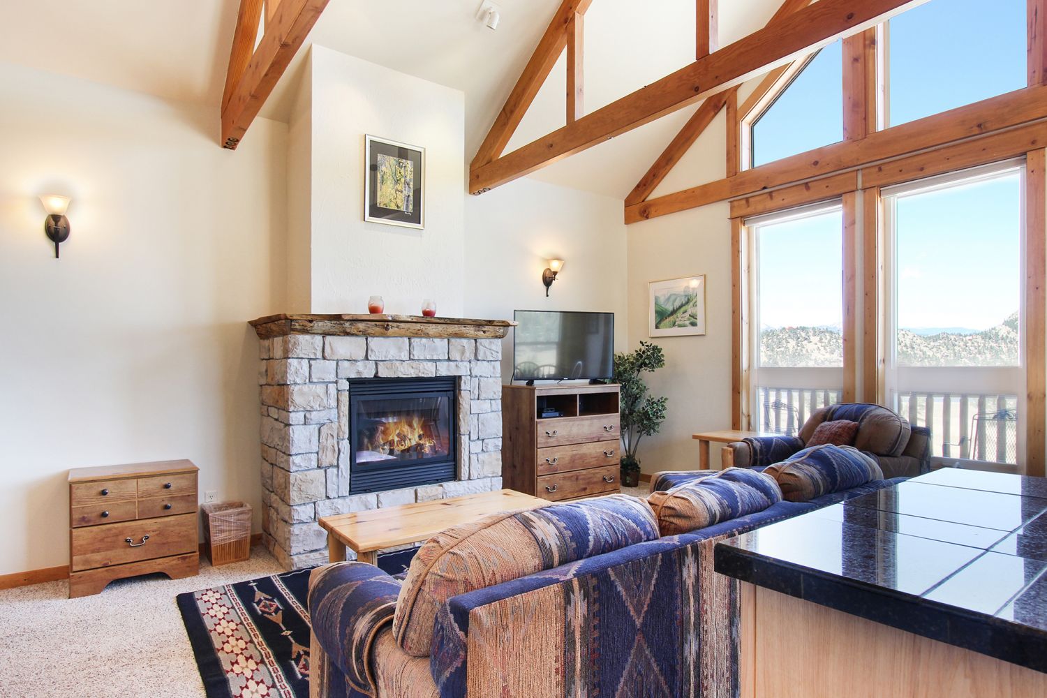 Comanche Peak 39 - Flat-screen TV and gorgeous stone fireplace in the main living area, floor to ceiling windows offer beautiful mountain views.
