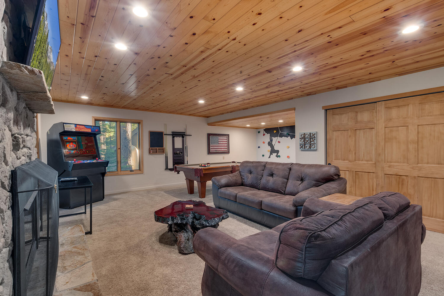 Recreation area with flat screen tv, fireplace, and upright arcade