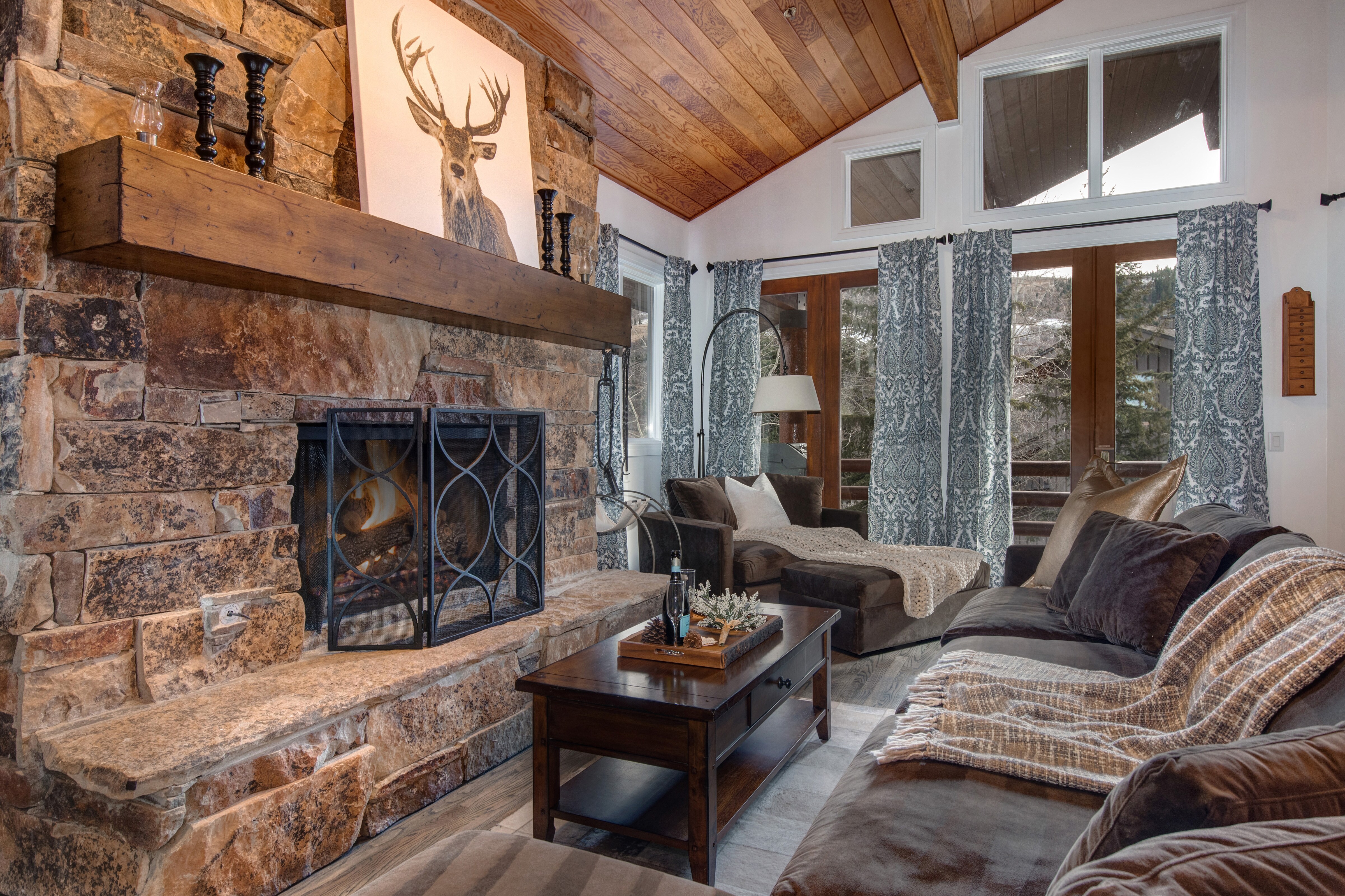 Living Room with gas-assist fireplace, plush over-sized sectional, wet bar, Samsung smart TV, vaulted ceilings, and deck access overlooking the Deer Valley Slopes