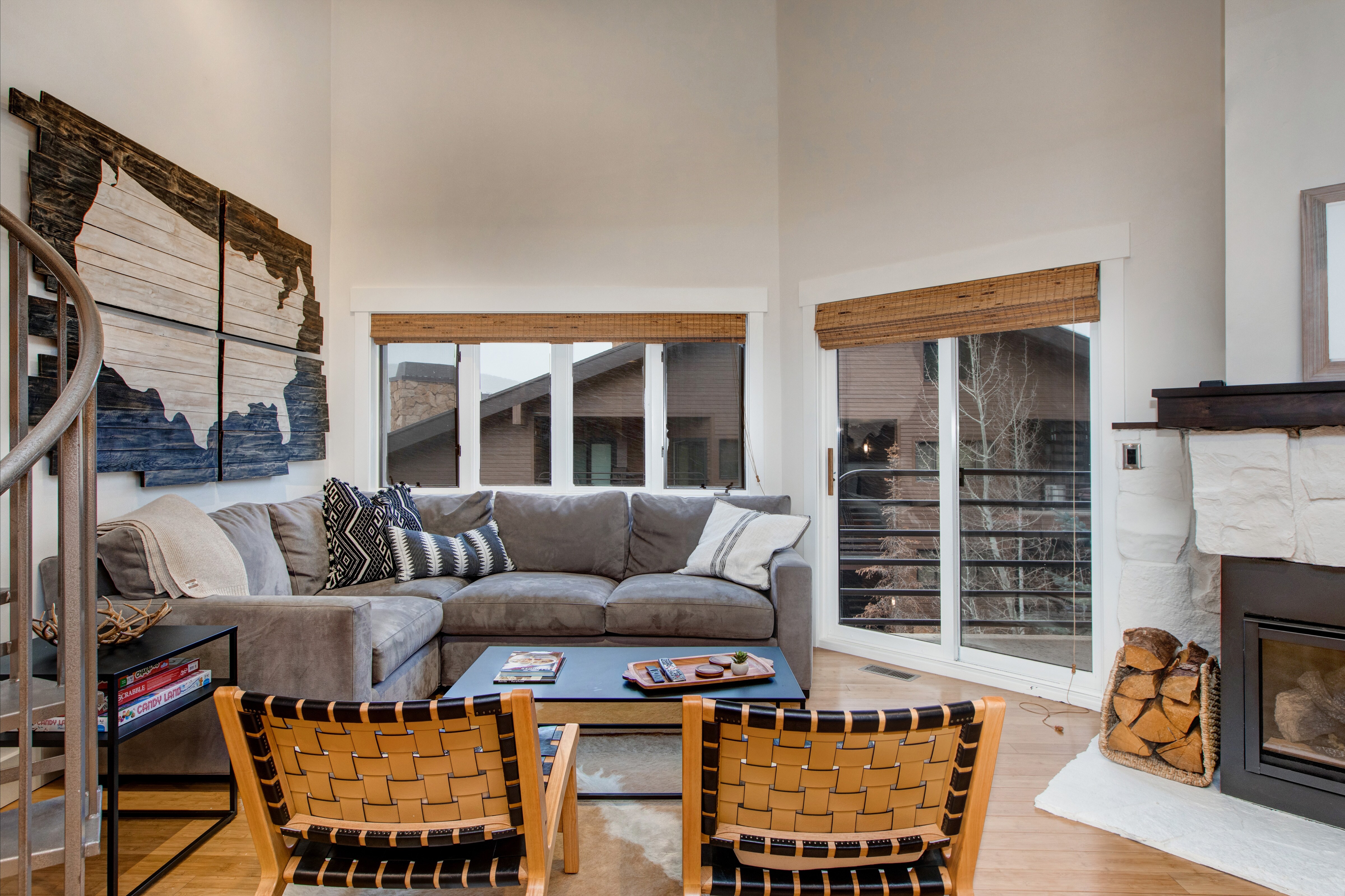 Living Room with samsung smart tv, private patio access, gas fireplace, and sectional with built in sofa-bed