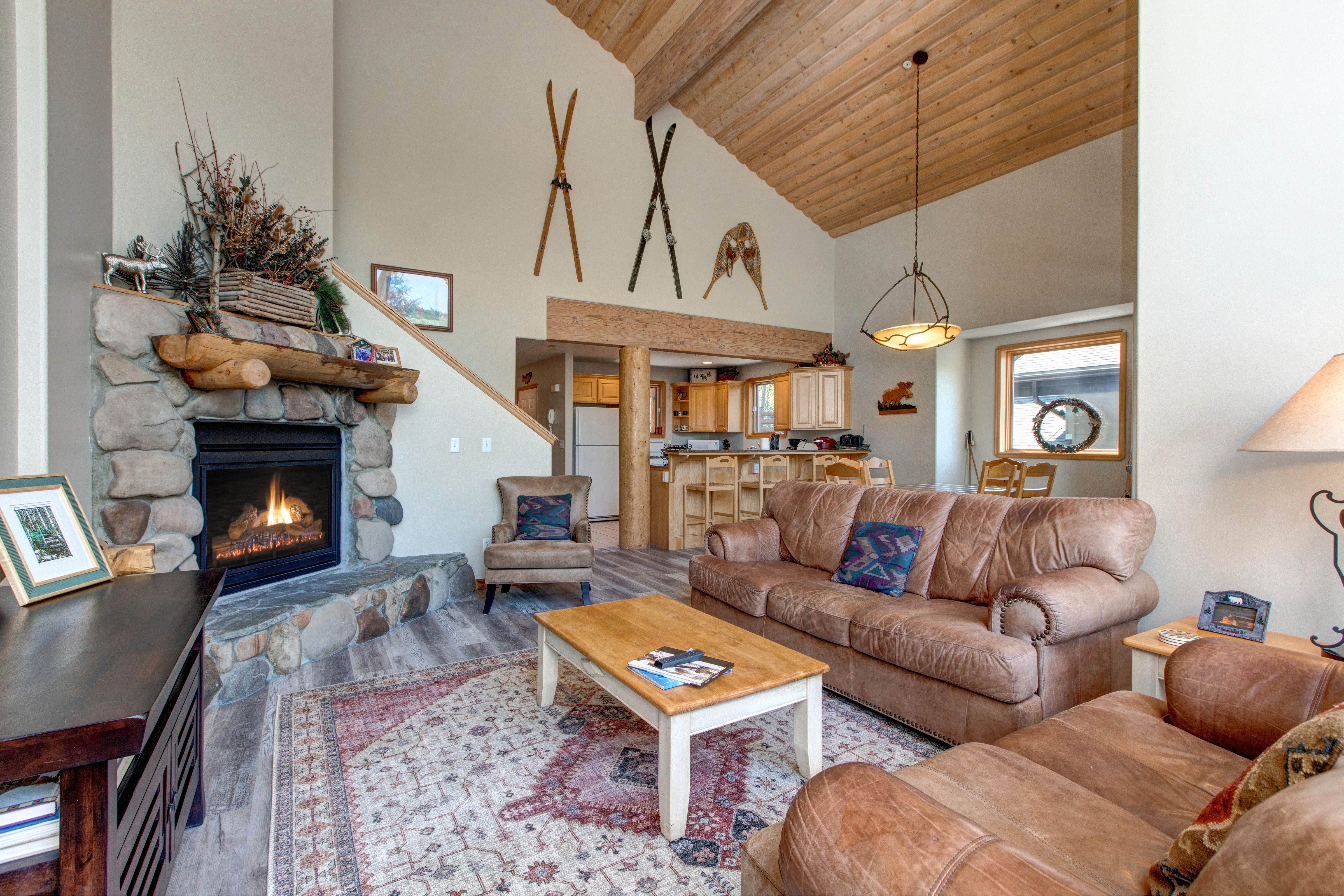 Living Room with floor to ceiling windows, gas fireplace, 58" Samsung Smart Tv, plush leather furnishings with sofa sleeper, and private balcony access