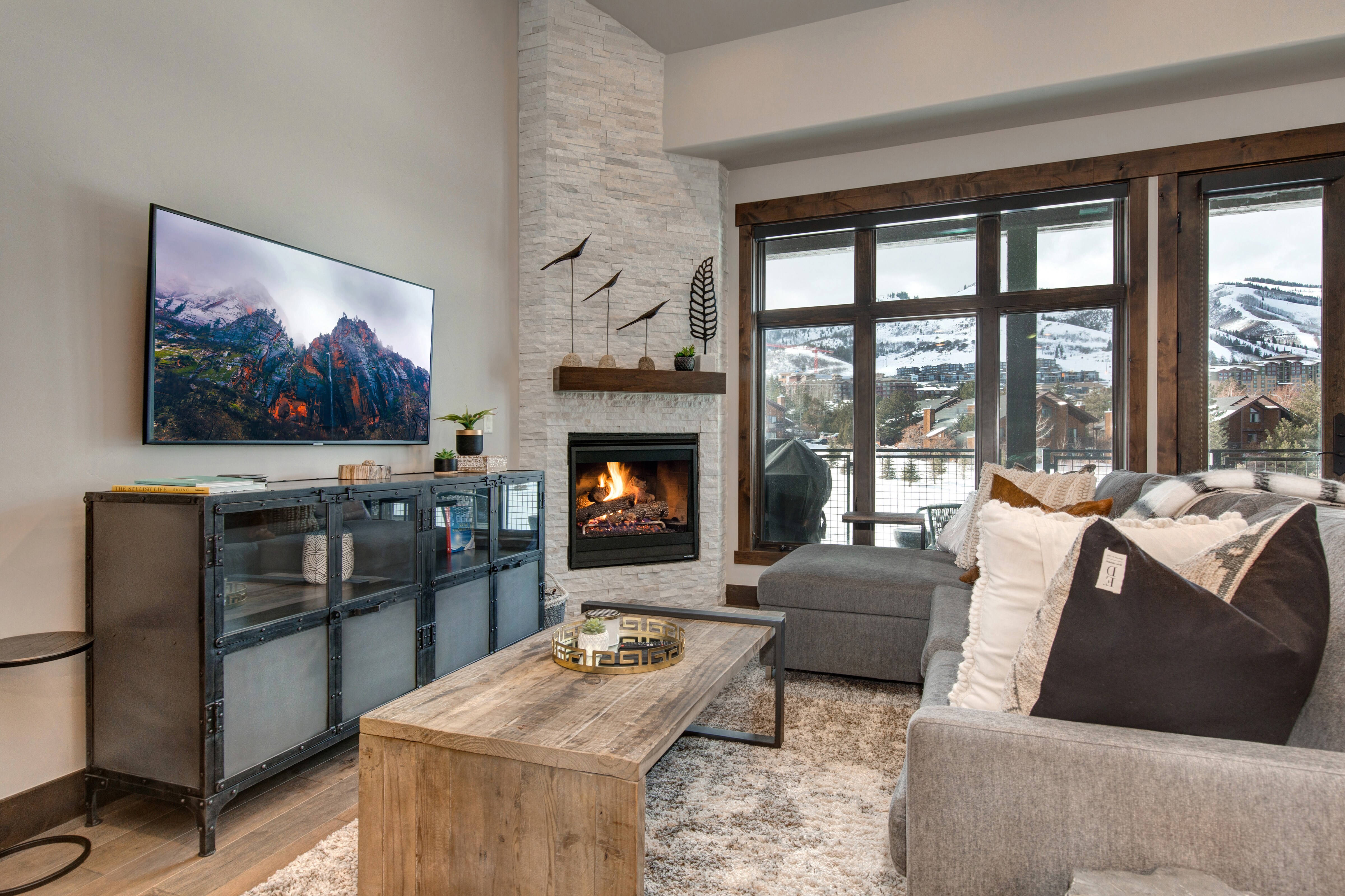 Professionally decorated Living Room with 55" Samsung smart tv, gas fireplace, large sectional sofa with sleeper, and breathtaking views of the Canyons Golf Course and Resort