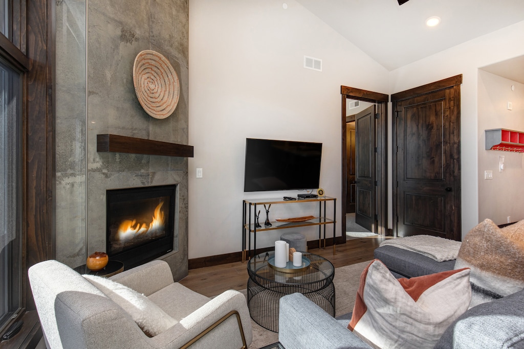Living Room with sleeper sofa, 55" Samsung smart TV and cozy gas fireplace.