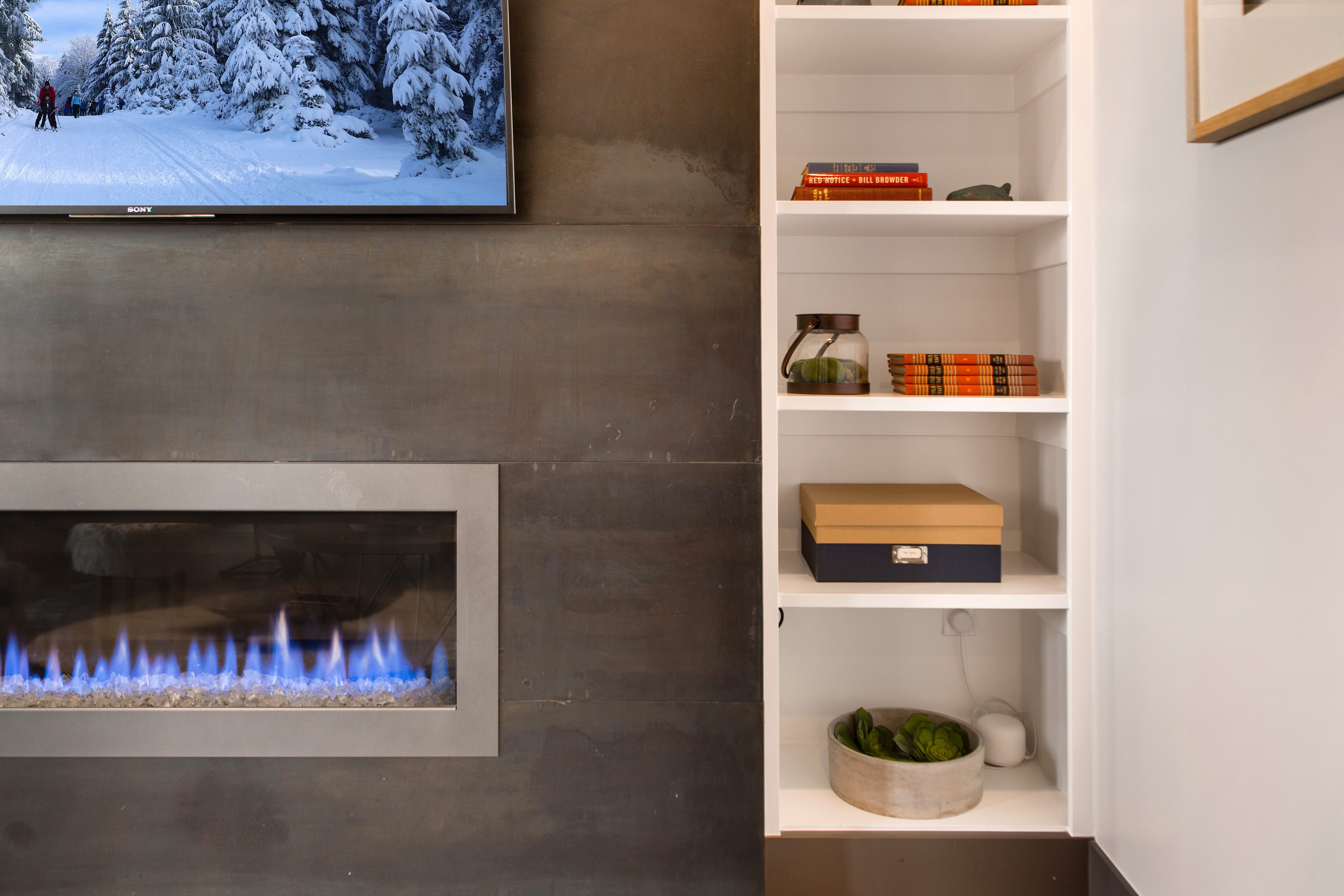 Living Room with plush contemporary furnishings, modern gas fireplace, Sony smart tv, and private balcony access