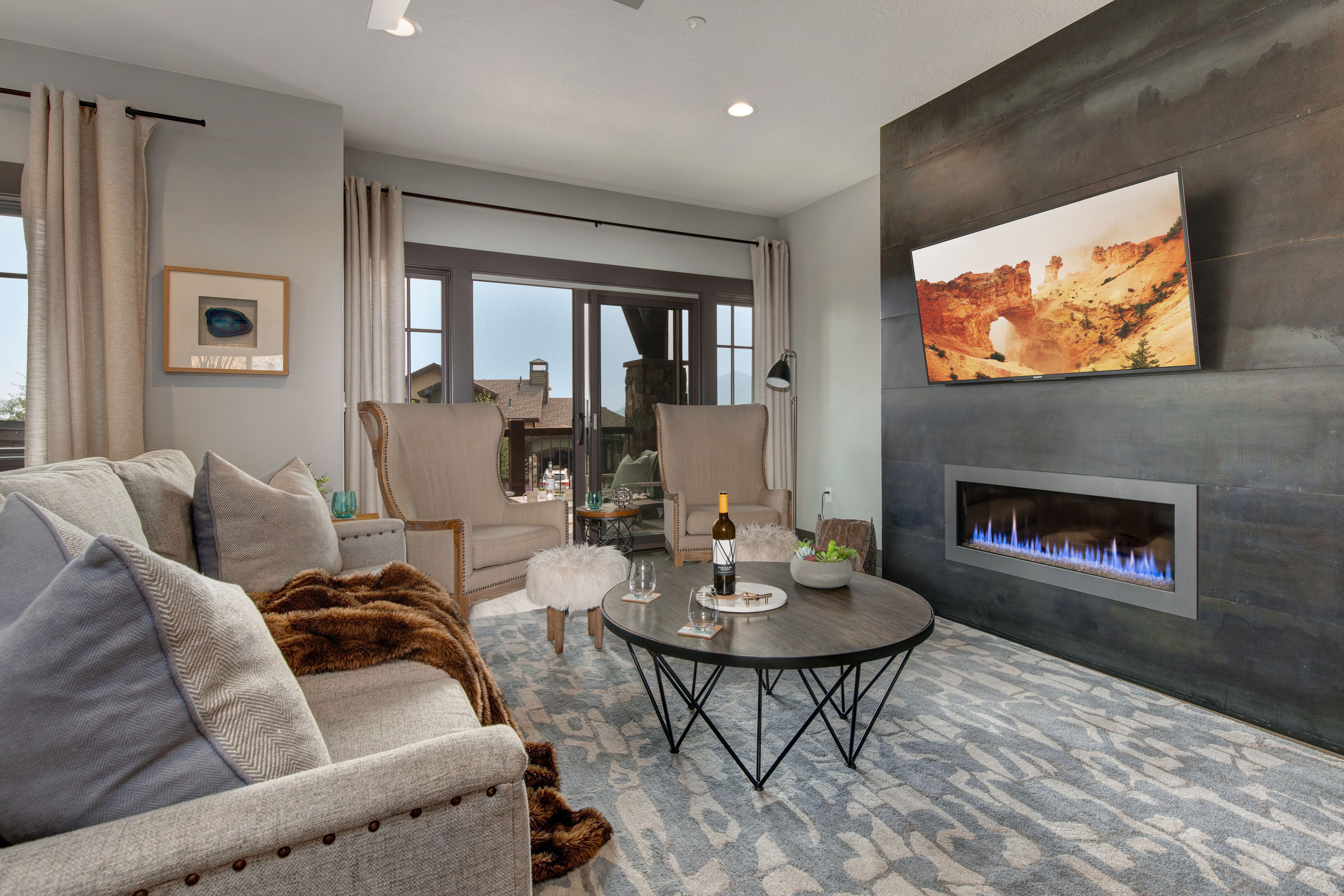 Living Room with plush contemporary furnishings, modern gas fireplace, Sony smart tv, and private balcony access