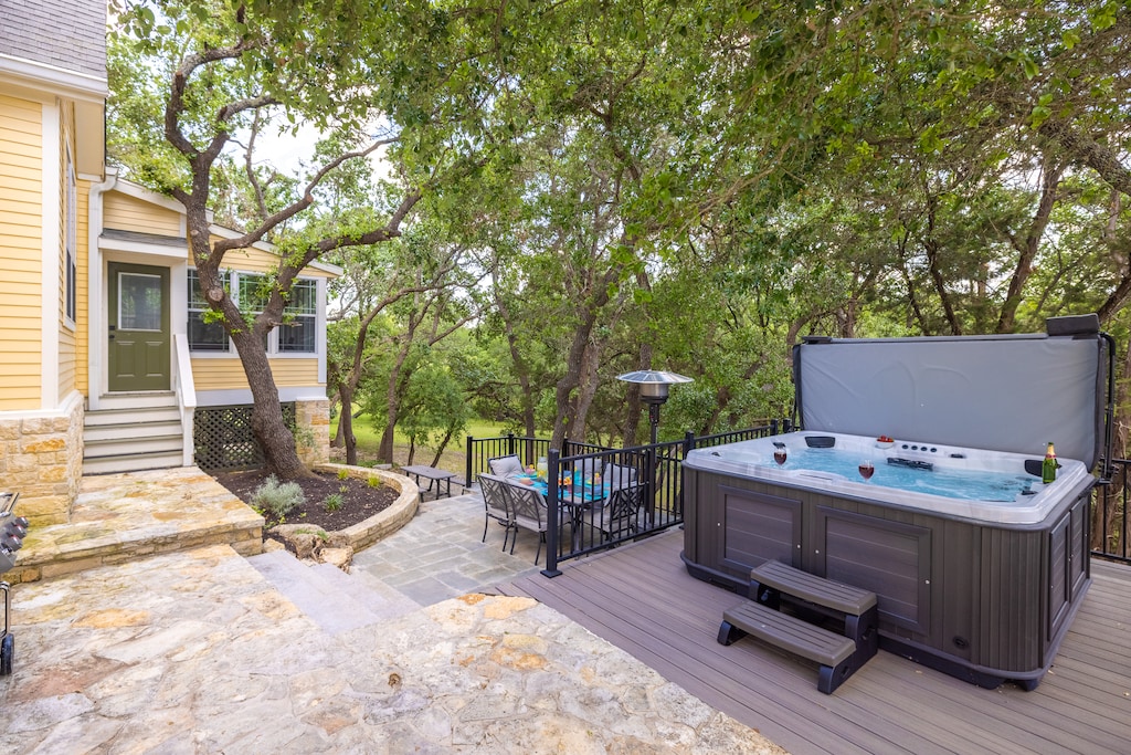 Back yard has heated plus plus big hot tub and multi-decks with outdoor dining and fire pits too