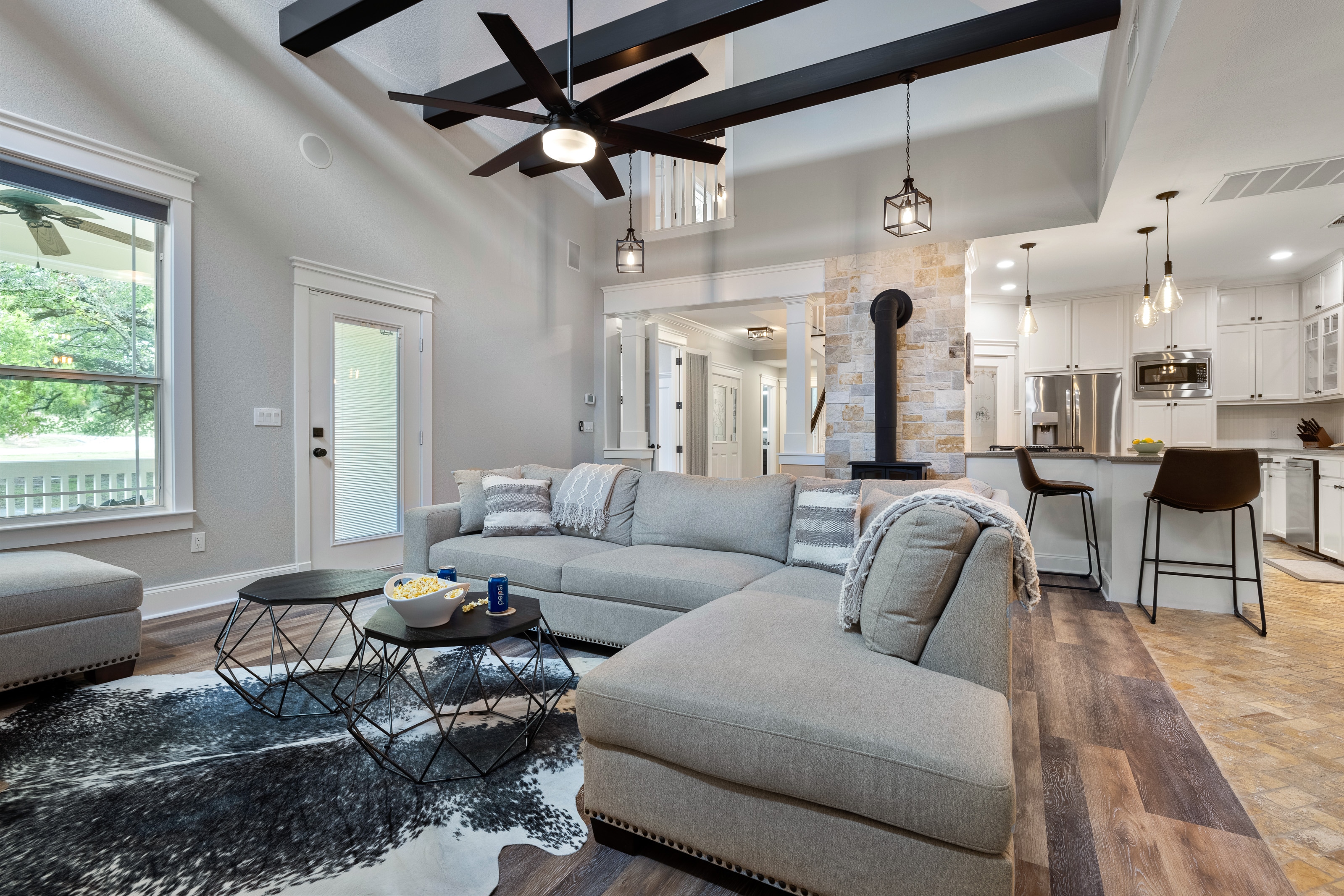 Living room with sectional and 75" Smart Direct TV with Sonos