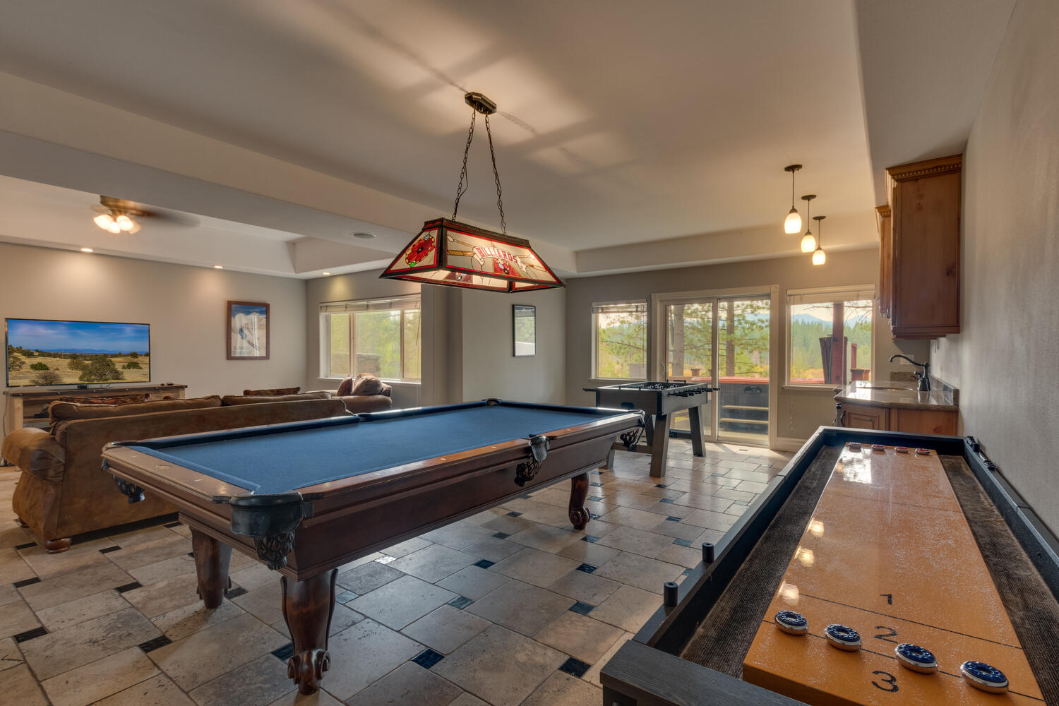 Living room with pool table and shuffle board