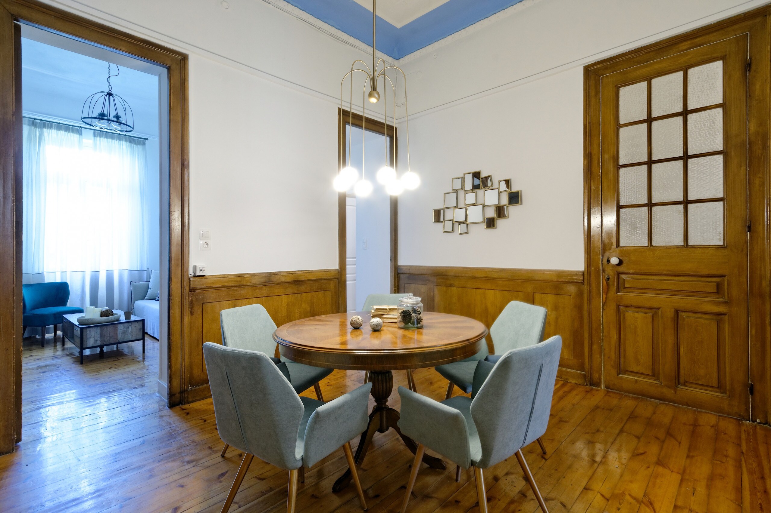 The dining area is at the heart of the apartment. The classy antique round table is the perfect place to chat about your day