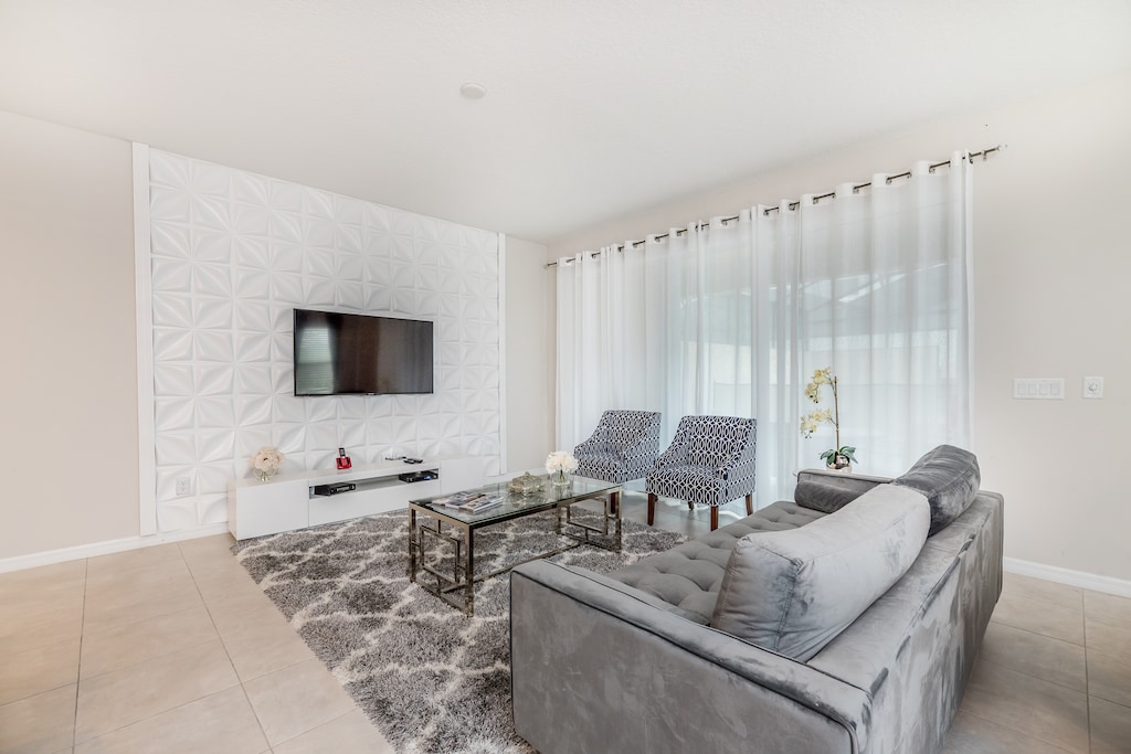 - Luxurious living area of the apartment in Kissimmee - Cosy sofas - Elegantly decored living area - Large bright windows of the living area with Mesmerizing views - Beautifully tile furnished floor - Availability of TV and Netflix