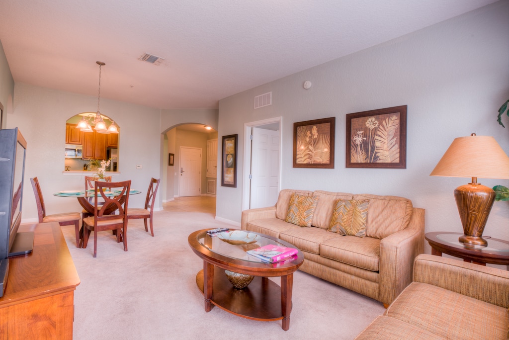 The living and dining room at Vista Cay Resort blend comfort and elegance, providing guests with a welcoming space to relax, dine, and create cherished memories.