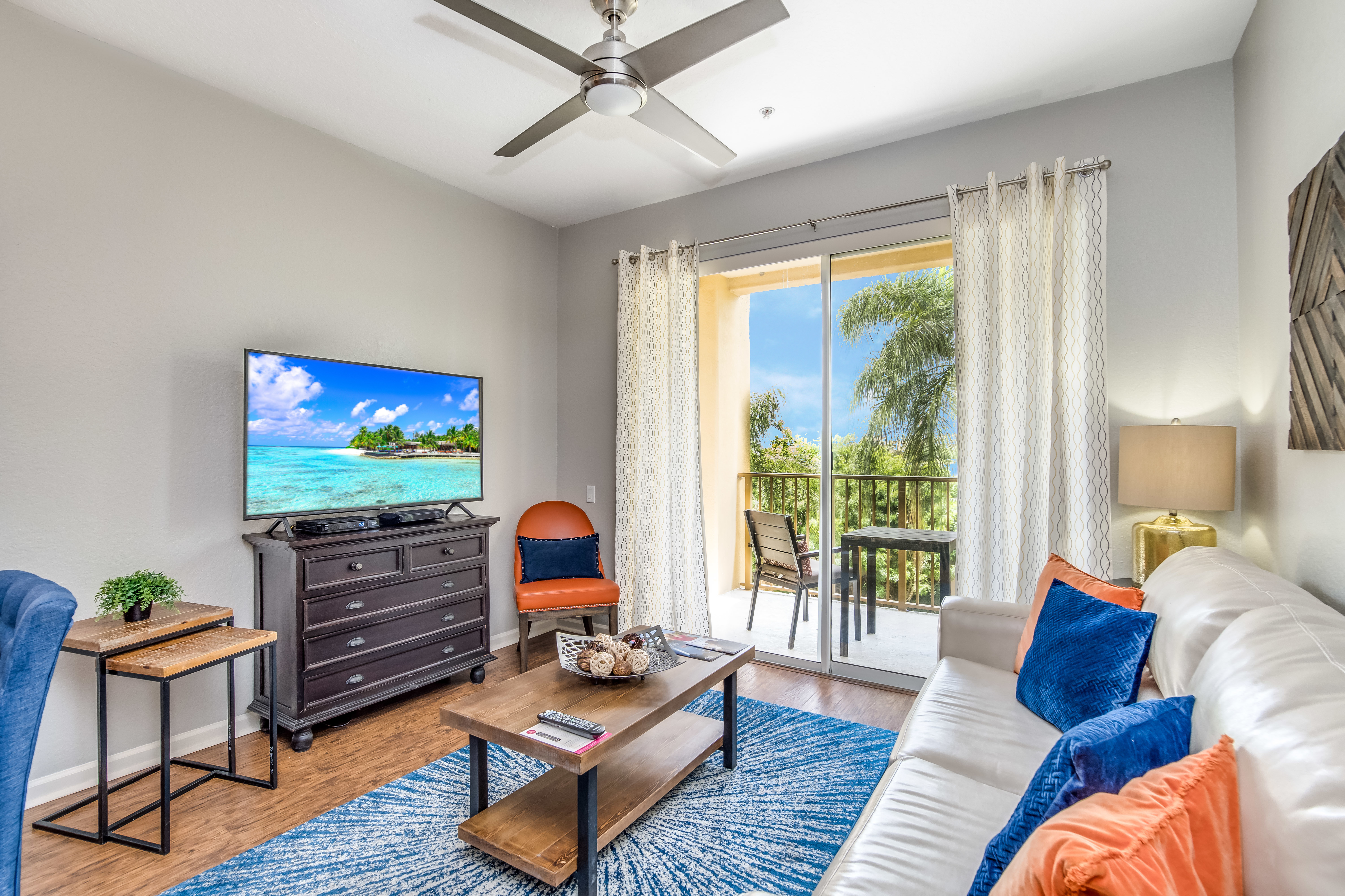 Spectacular living room of the condo in  in Orlando - Magnificent private balcony with mesmerizing lake views - Availability of a 55" TV for entertainment - Offering the perfect blend of relaxation and entertainment with cozy sofas