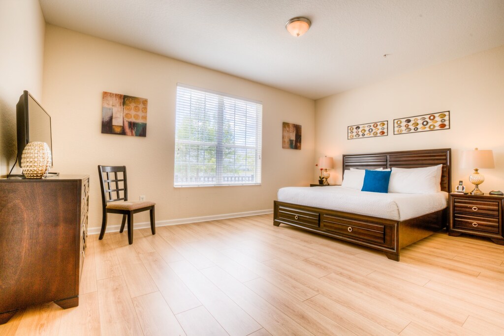 Unwind in luxury in this spacious main bedroom featuring a king-sized bed and a private en-suite bathroom.