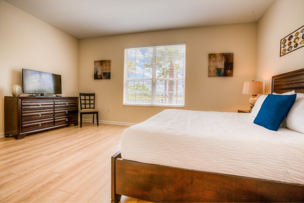 Retreat in Style: Unwind in the luxurious main bedroom featuring a king-size bed and an en-suite bathroom. Experience ultimate comfort and relaxation in this elegant sanctuary