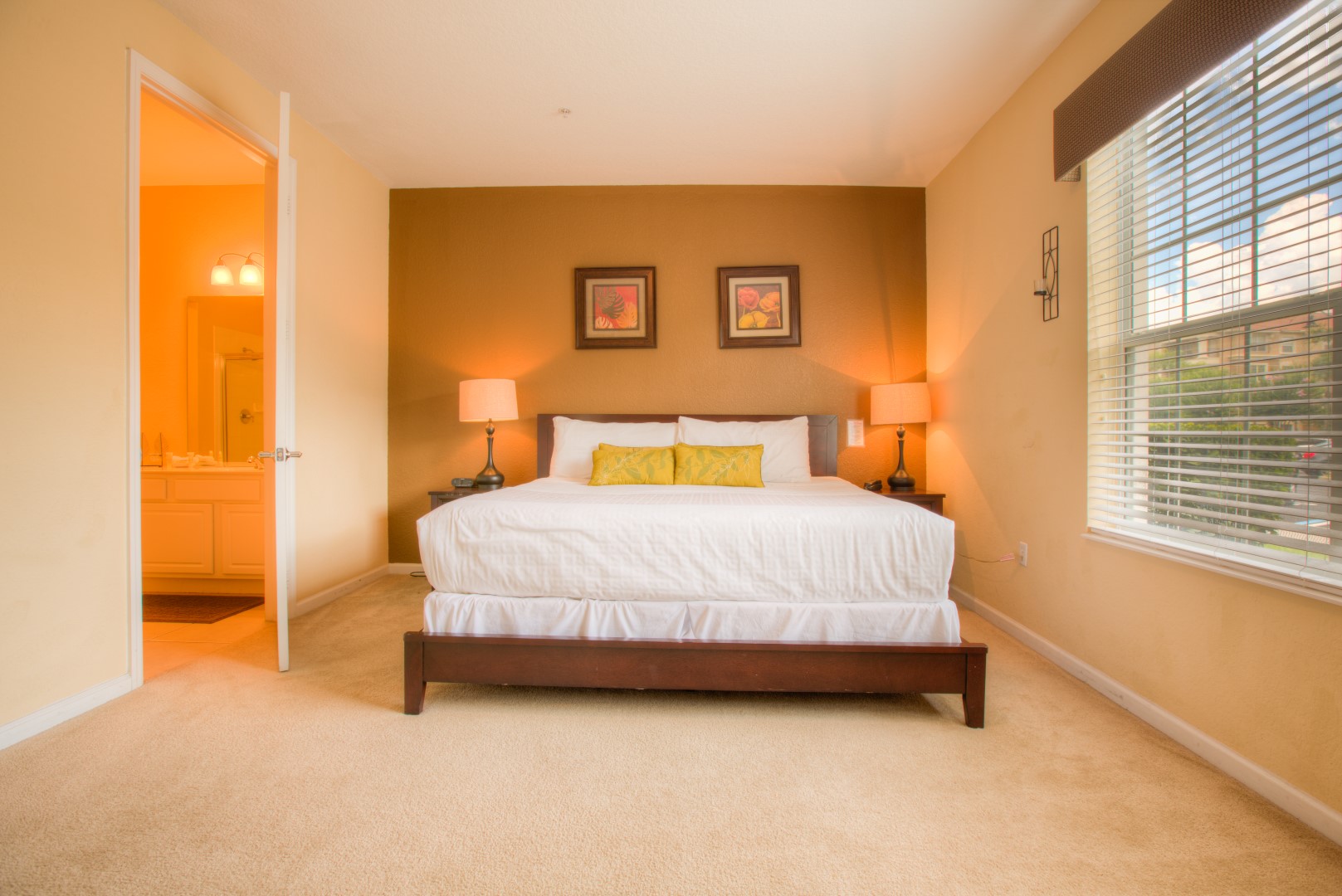Relaxing bedroom of the condo in Orlando - Rustic colored wall to warm up the space. - Plush bedding with neat and clean linen - Stunningly carpeted floor - Attached bathroom for your convenience - Bedside window to rise with lovely outside views