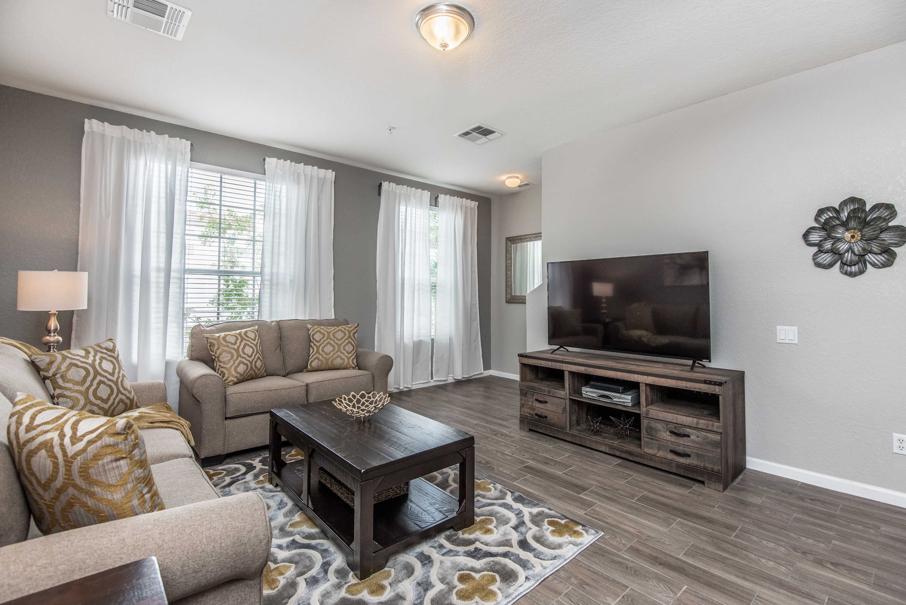 Serene Living Space with a View: Admire the scenic beauty through large windows while lounging in the tranquility of our thoughtfully decorated living room