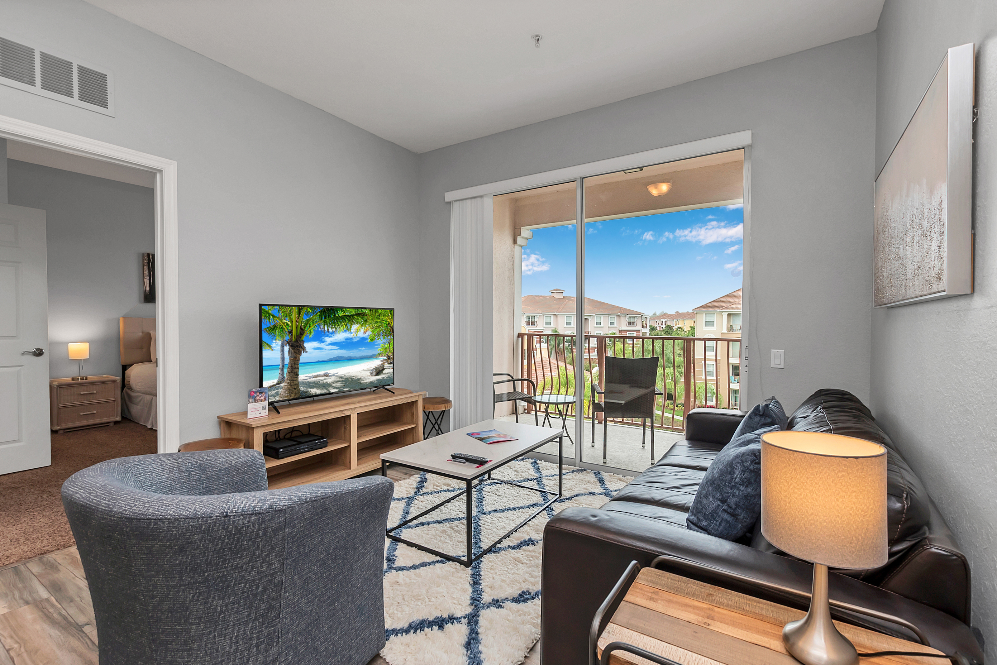 - Enchanting living area of the condo in Orlando Florida - Smart TV and Netflix - Chic and contemporary living area design with modern furnishings - Cozy seating area with sofas - Big and bright sliding doors that leads to the private balcony