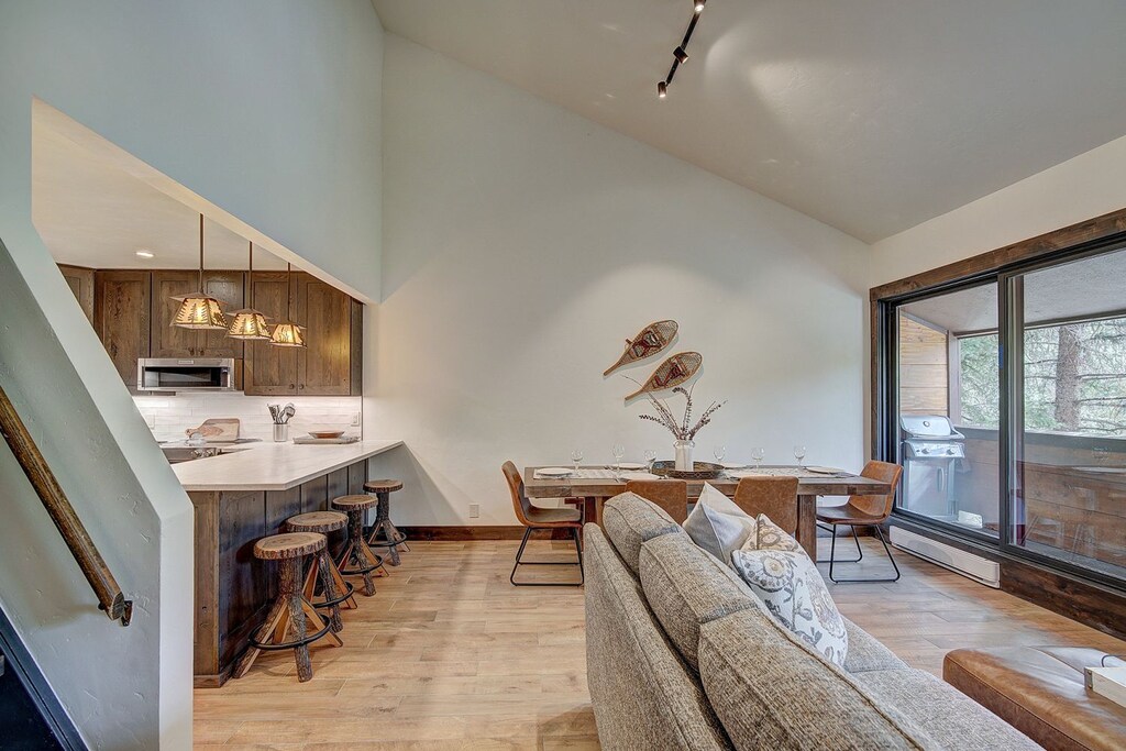 Living room opens into dining area with cathedral ceilings - 