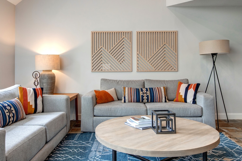 Main Level Living Room with floor to ceiling windows, gas fireplace, plush furnishings with sofa sleeper, 75" Samsung smart tv, and breathtaking views of Deer Valley