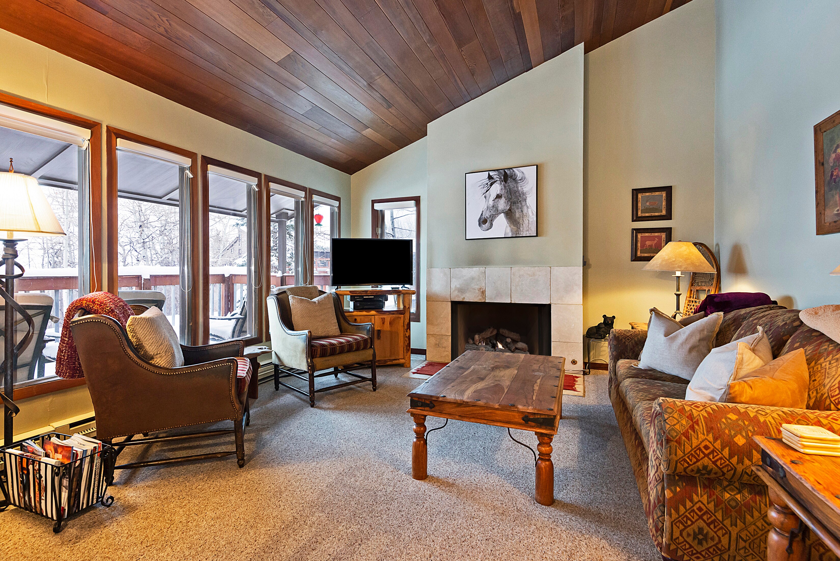 Cozy Living Room with a Gas Fireplace, Smart TV and Plenty of Windows to Bring in the Natural Light