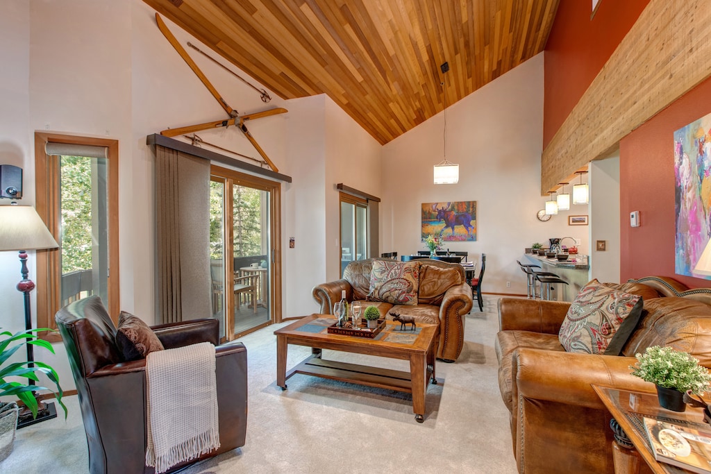 Living Room with plush leather furnishings, 50" TV, gas fireplace, piano, wall-mounted stereo system, and private balcony access