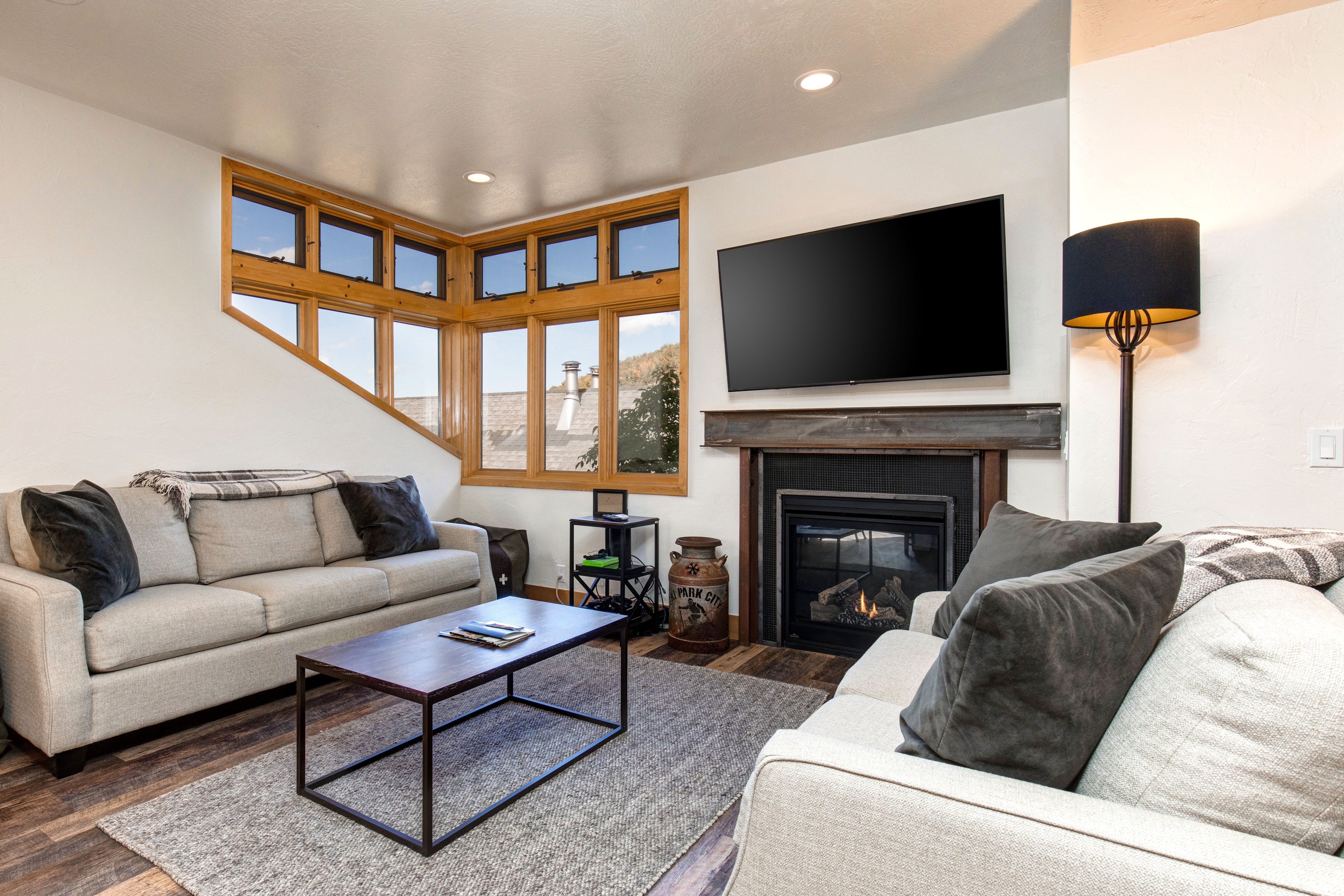 Cozy Main Level Living Room with a Gas Fireplace and 65" Smart TV