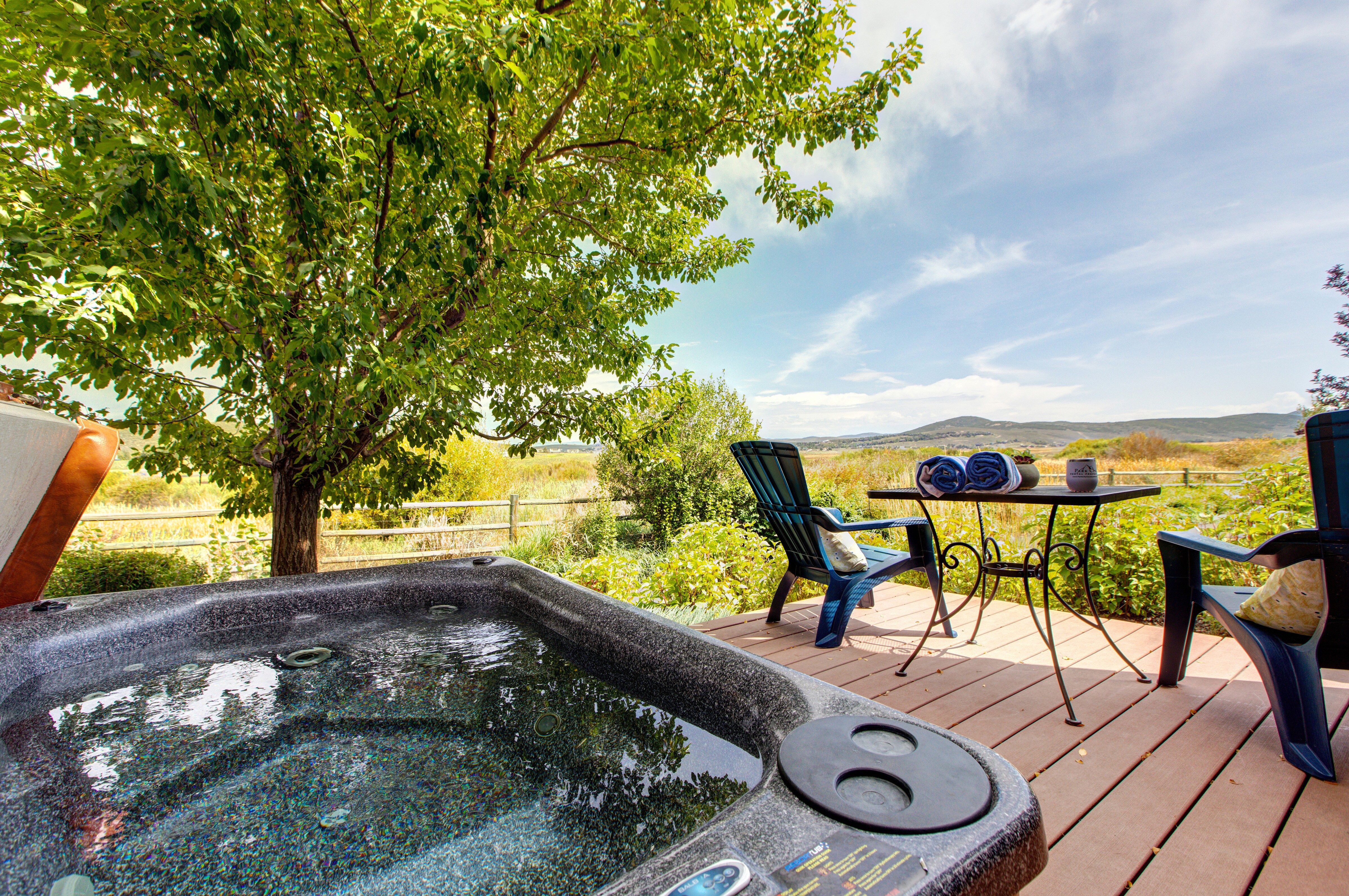 Main Level private patio with hot tub, table and chairs for two, and spectacular surrounding views of the nature preserve and biking/hiking trails